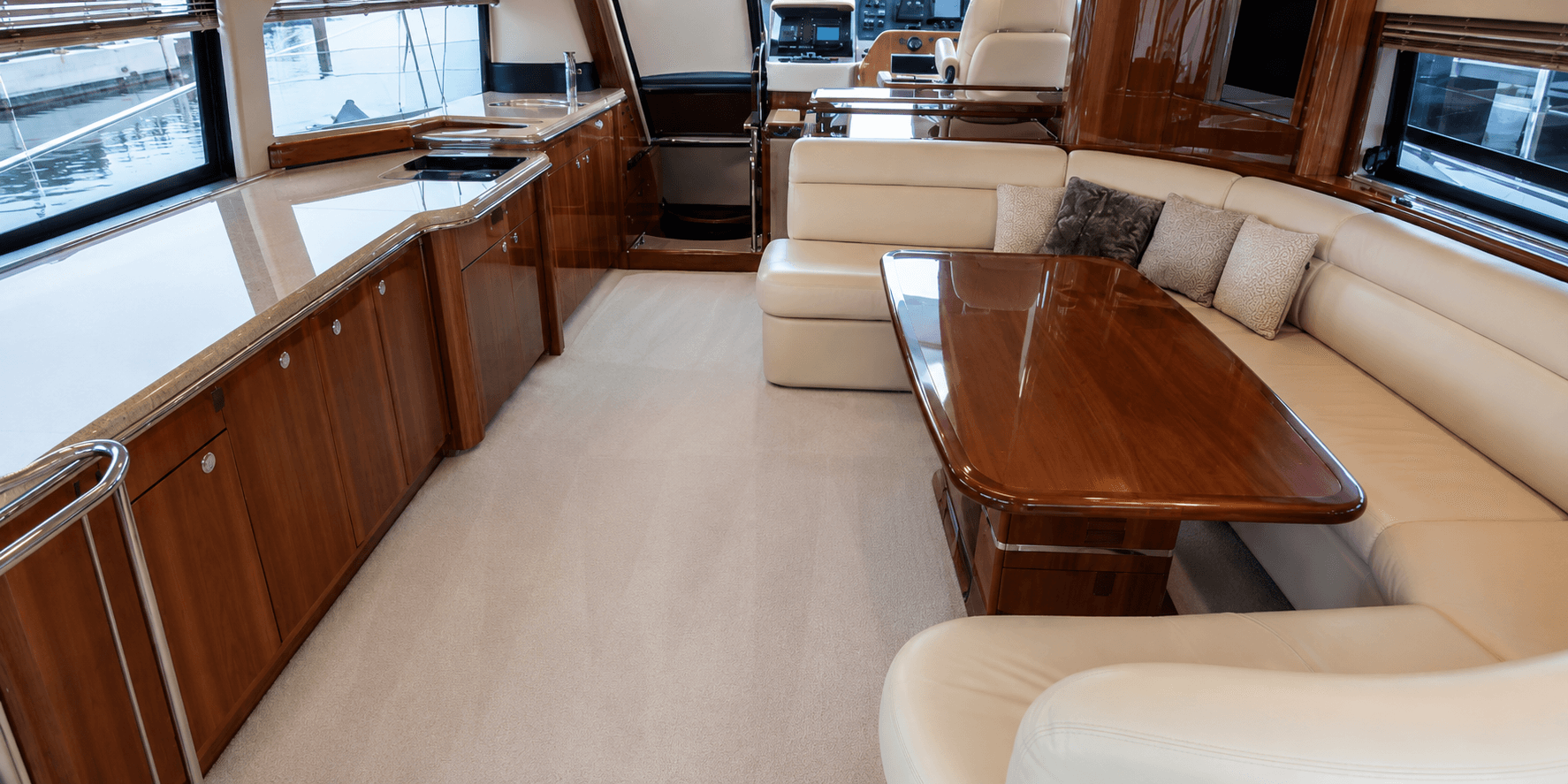After interior yacht cleaning: spotless salon with clean upholstery carpet and staged details
